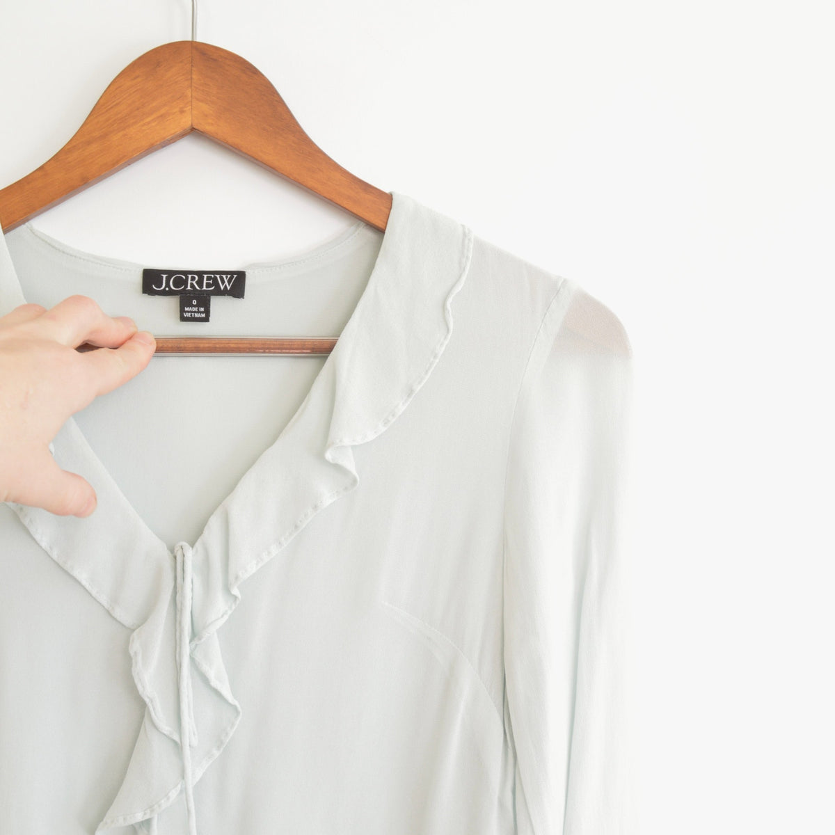 light blue cropped ruffly tie front blouse