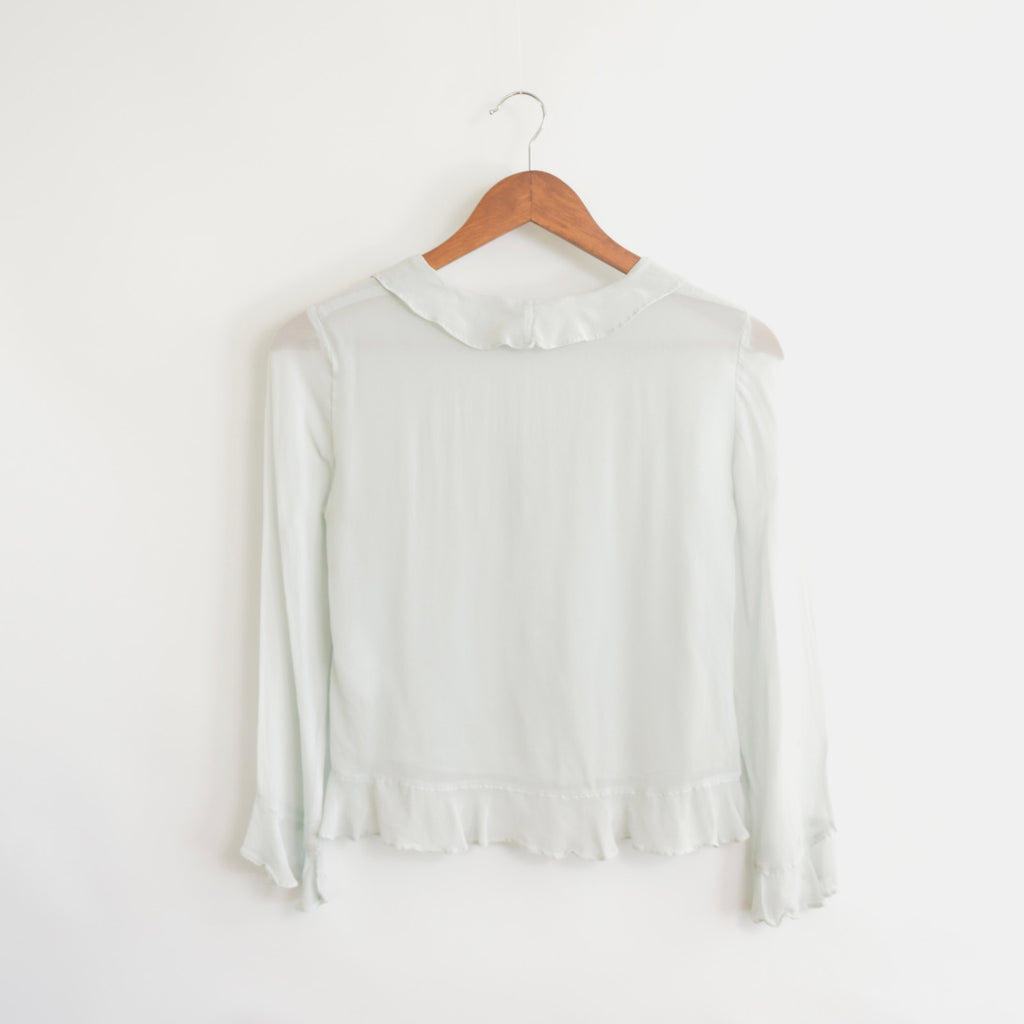 light blue cropped ruffly tie front blouse