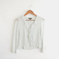 light blue cropped ruffly tie front blouse