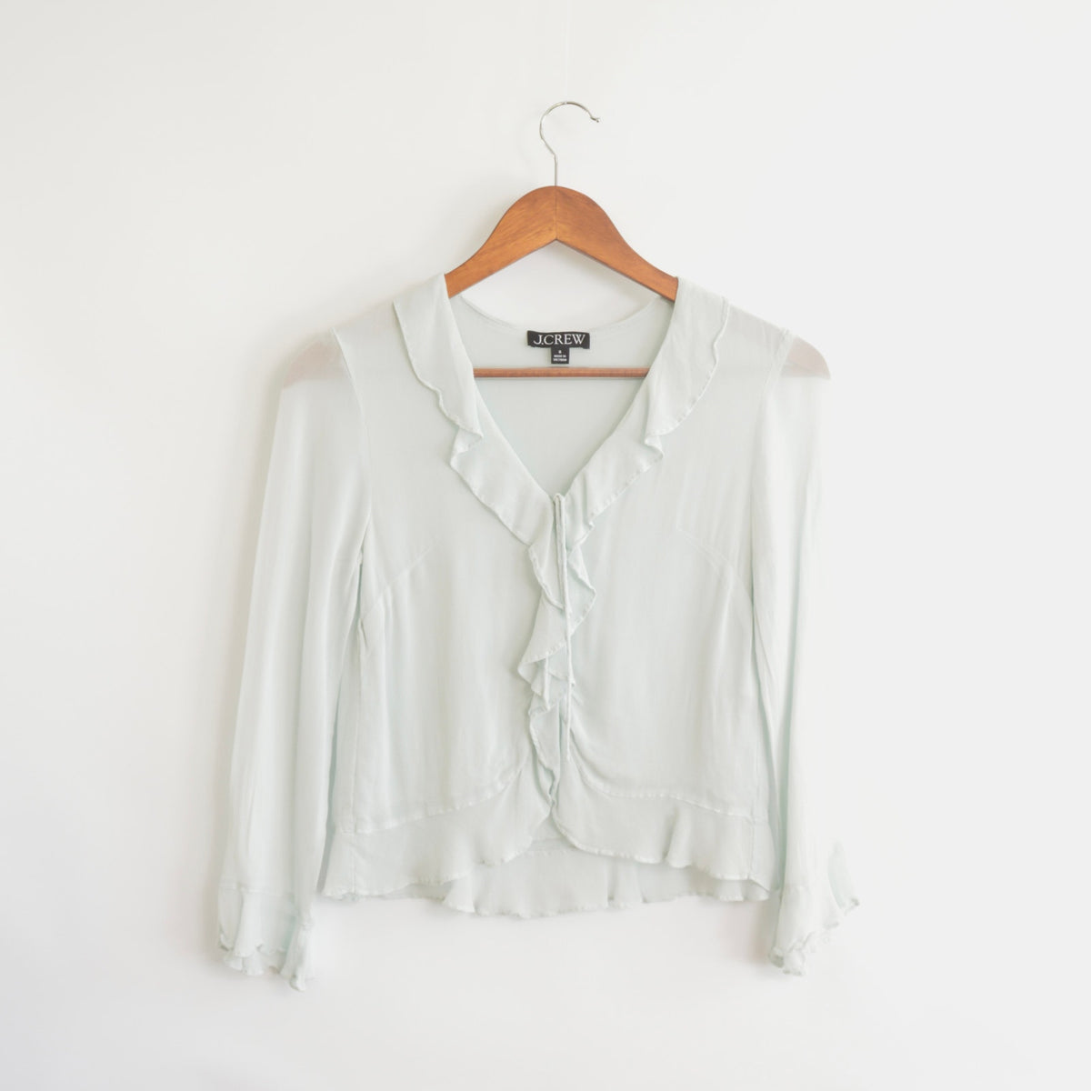 light blue cropped ruffly tie front blouse
